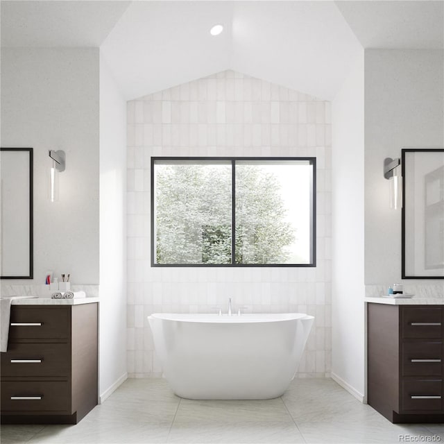 967 W Elk Meadows Dr, Tabernash, CO 80446 - bathroom featuring vanity, a soaking tub, vaulted ceiling, and tile walls