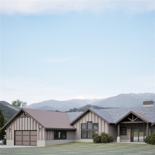 967 W Elk Meadows Dr, Tabernash, CO 80446 - view of front of house featuring a mountain view, board and batten siding, a garage, and stone siding