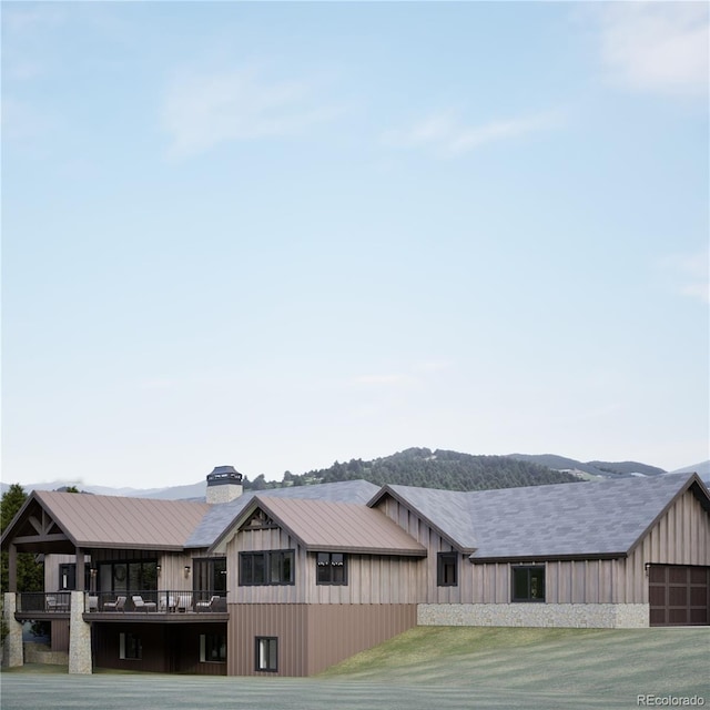 967 W Elk Meadows Dr, Tabernash, CO 80446 - back of property featuring a balcony, board and batten siding, and a chimney