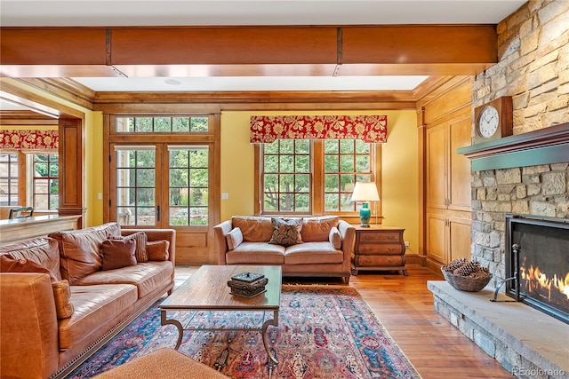 living area featuring a fireplace, light wood-style floors, and plenty of natural light