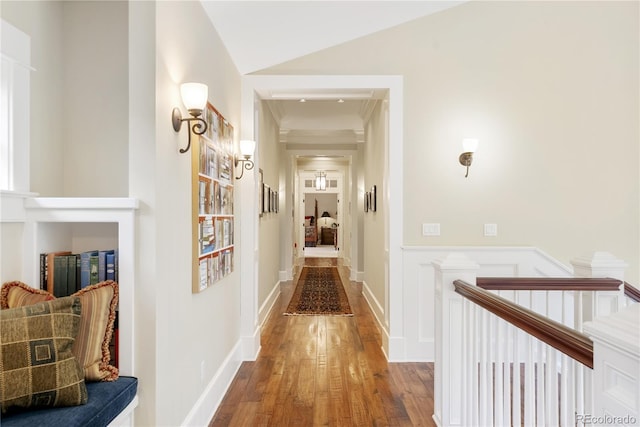 hallway with vaulted ceiling and wood finished floors