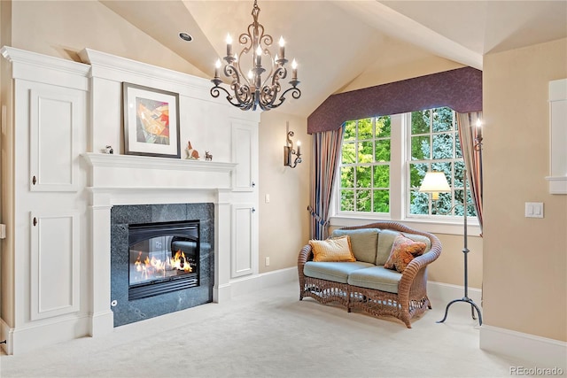 living area with vaulted ceiling, carpet, a premium fireplace, baseboards, and a notable chandelier