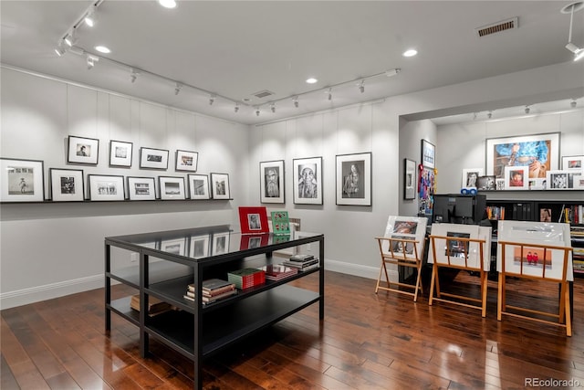 dining area with baseboards, hardwood / wood-style flooring, visible vents, and rail lighting