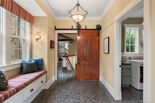 foyer featuring granite finish floor, crown molding, baseboards, and a barn door