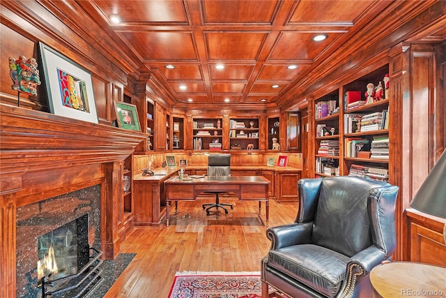 home office with light wood-type flooring, built in shelves, a fireplace, wooden ceiling, and wood walls