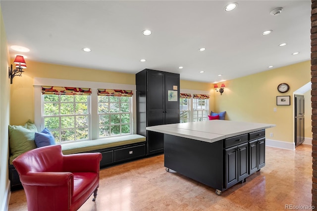 kitchen featuring recessed lighting, a healthy amount of sunlight, and dark cabinets