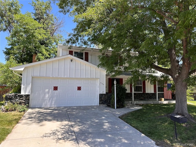 4184 S Syracuse St, Denver, CO 80237 - view of front of property with board and batten siding, concrete driveway, a garage, stone siding, and a chimney