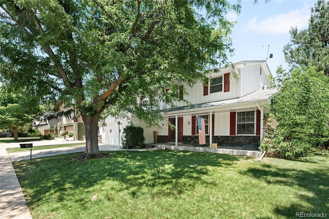 4184 S Syracuse St, Denver, CO 80237 - view of front facade featuring covered porch, stone siding, a front lawn, concrete driveway, and board and batten siding
