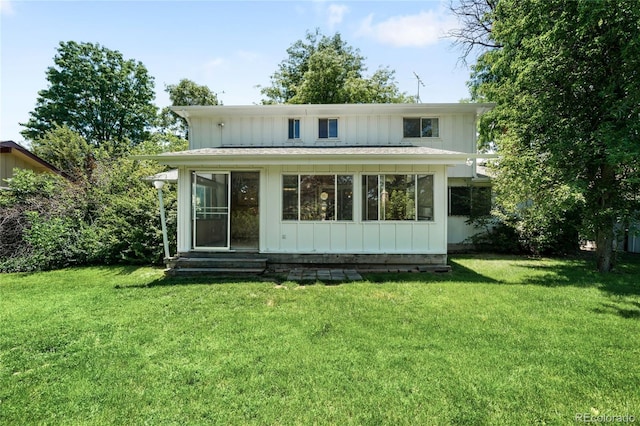 4184 S Syracuse St, Denver, CO 80237 - back of house featuring board and batten siding, a sunroom, and a yard
