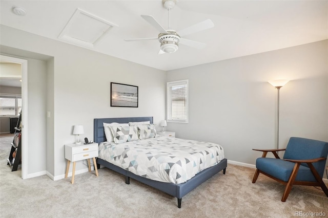 bedroom with light colored carpet, attic access, and multiple windows