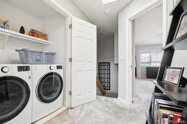 laundry area featuring washer and dryer, baseboards, carpet floors, and laundry area