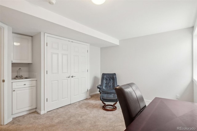 office with light colored carpet, baseboards, and a sink