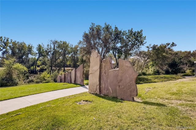 surrounding community with a yard and fence