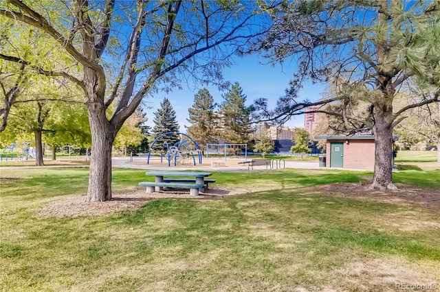 surrounding community with a yard and playground community