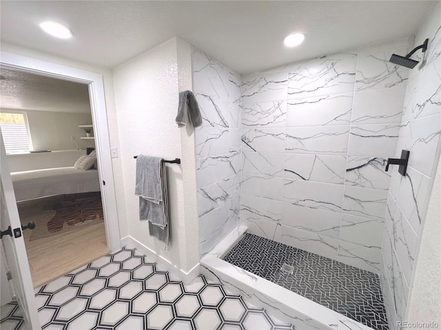 bathroom featuring wood-type flooring and tiled shower