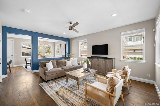 living area featuring wood finished floors, baseboards, ceiling fan, and recessed lighting