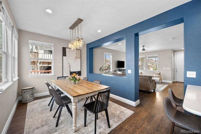dining space featuring ceiling fan with notable chandelier, baseboards, recessed lighting, and wood finished floors