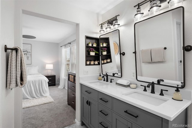 ensuite bathroom featuring a sink, double vanity, and connected bathroom