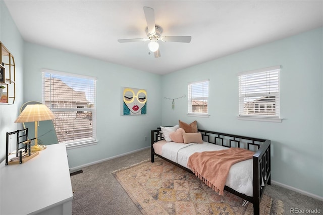 carpeted bedroom with baseboards, a ceiling fan, and multiple windows
