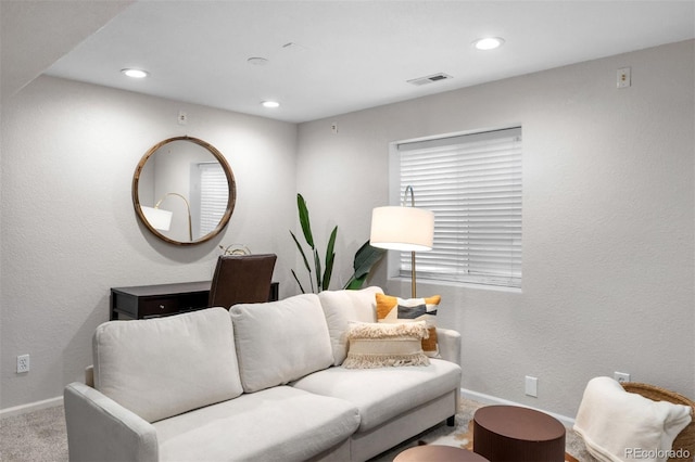 carpeted living room with baseboards, recessed lighting, and visible vents