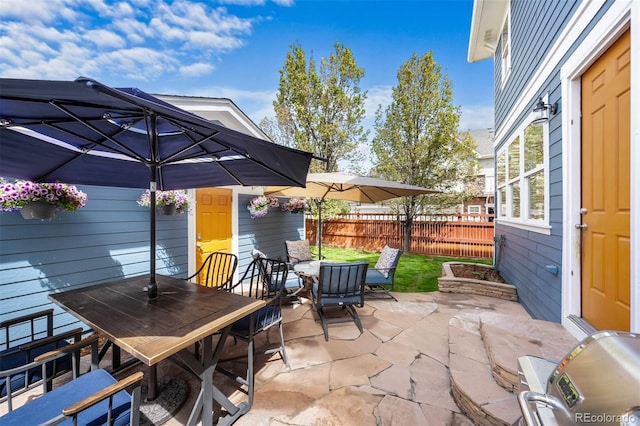 view of patio with fence and outdoor dining space