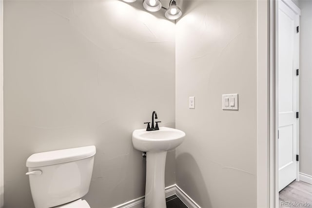 bathroom featuring sink, hardwood / wood-style flooring, and toilet