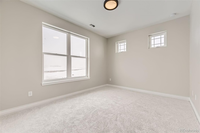 carpeted empty room with a wealth of natural light