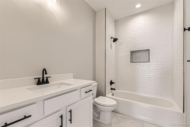 full bathroom featuring vanity, toilet, and tiled shower / bath