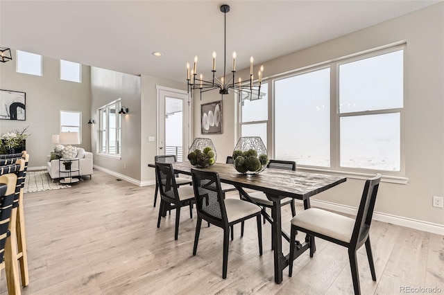 dining room featuring an inviting chandelier and light wood-type flooring