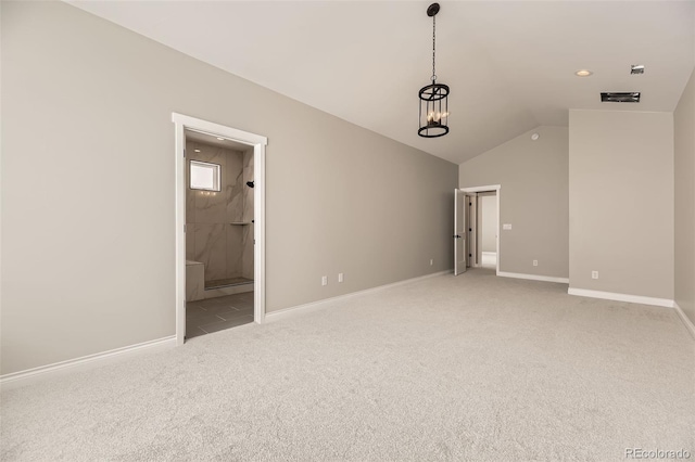 unfurnished bedroom with an inviting chandelier, lofted ceiling, connected bathroom, and light carpet