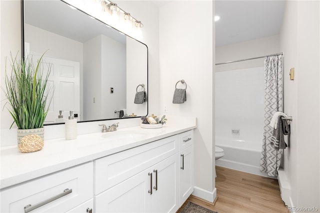 full bathroom featuring vanity, hardwood / wood-style flooring, toilet, and shower / bath combo with shower curtain