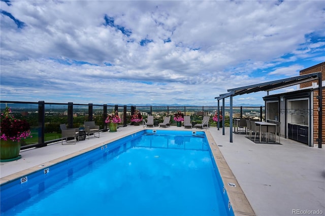 view of swimming pool with a patio area