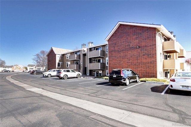 view of property featuring uncovered parking and a residential view