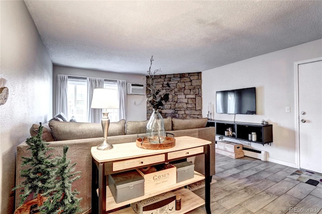 living room with a textured ceiling, a wall mounted air conditioner, and wood finished floors