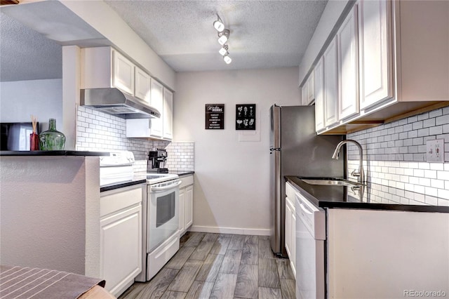 kitchen with tasteful backsplash, white cabinets, white appliances, and a textured ceiling