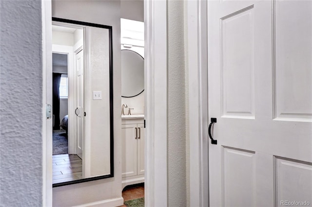 hall with sink and tile floors