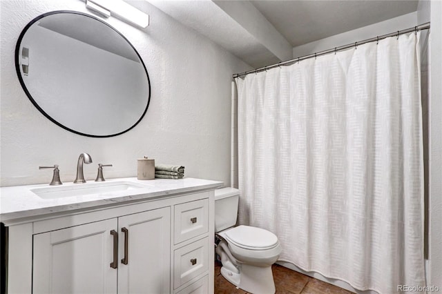 bathroom with toilet, tile flooring, and vanity