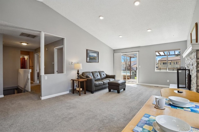 living room with visible vents, baseboards, vaulted ceiling, and carpet floors
