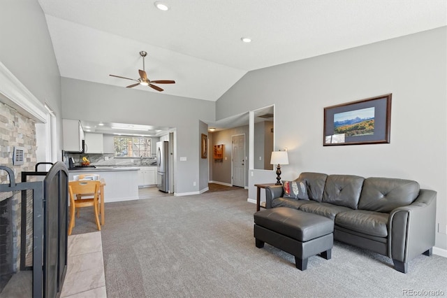 living area featuring baseboards, ceiling fan, recessed lighting, vaulted ceiling, and light colored carpet