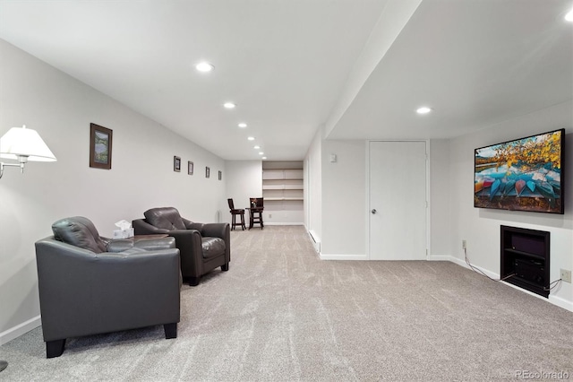 living area with light carpet, baseboards, and recessed lighting