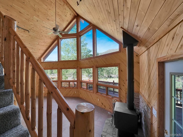 270 River Run Dr, Antonito, CO 81120 - living area with wooden ceiling, lofted ceiling, a wood stove, wooden walls, and stairway