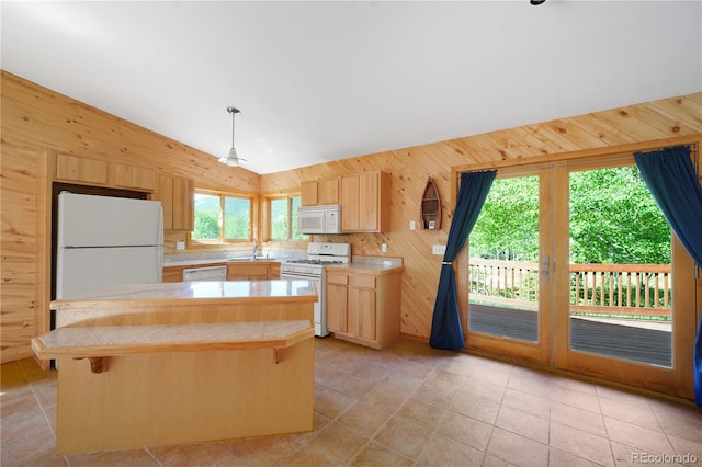 270 River Run Dr, Antonito, CO 81120 - kitchen featuring white appliances, lofted ceiling, wood walls, light brown cabinetry, and light countertops