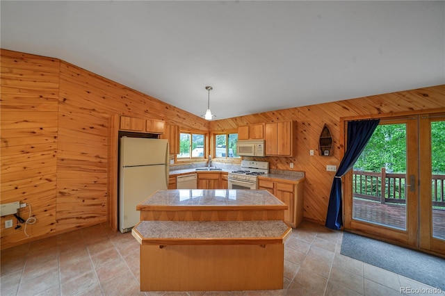 270 River Run Dr, Antonito, CO 81120 - kitchen featuring white appliances, lofted ceiling, tile countertops, wooden walls, and a center island