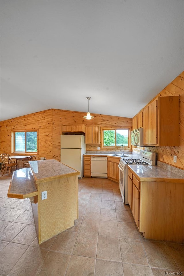 270 River Run Dr, Antonito, CO 81120 - kitchen featuring white appliances, wood walls, stone tile flooring, a kitchen island, and tile counters