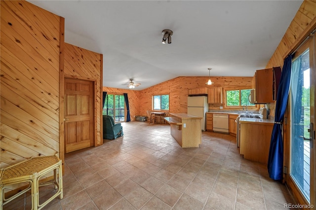 270 River Run Dr, Antonito, CO 81120 - kitchen with white appliances, wood walls, light countertops, healthy amount of natural light, and open floor plan