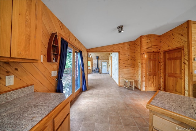 270 River Run Dr, Antonito, CO 81120 - kitchen with wooden walls, lofted ceiling, a wood stove, and open shelves