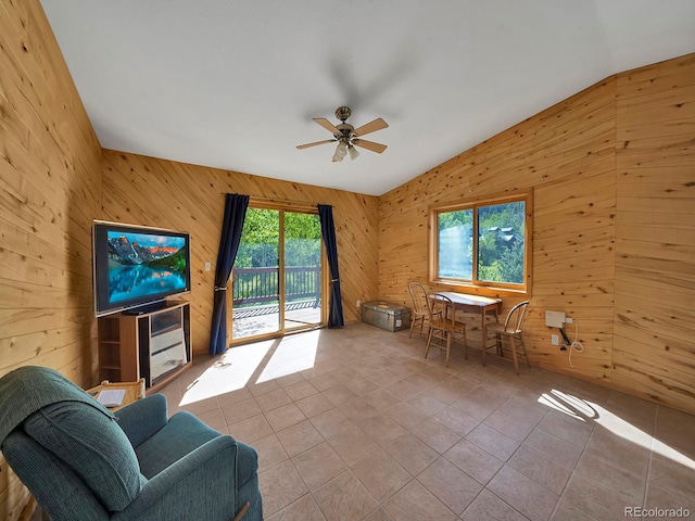 270 River Run Dr, Antonito, CO 81120 - living area with wooden walls, vaulted ceiling, ceiling fan, and tile patterned floors