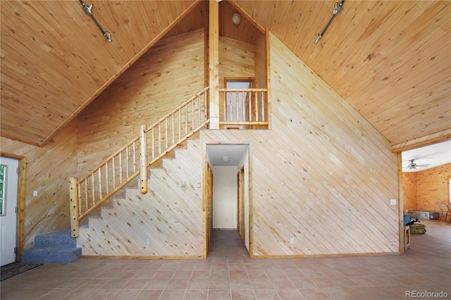 270 River Run Dr, Antonito, CO 81120 - staircase with rail lighting, wooden walls, high vaulted ceiling, wood ceiling, and tile patterned floors