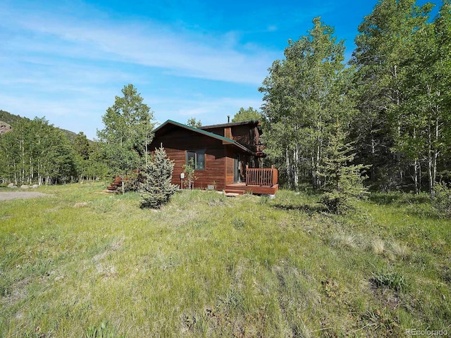 270 River Run Dr, Antonito, CO 81120 - rear view of house with a wooden deck and a forest view