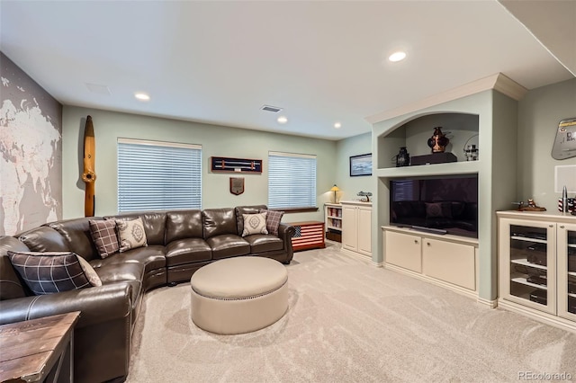 carpeted living room with recessed lighting and visible vents